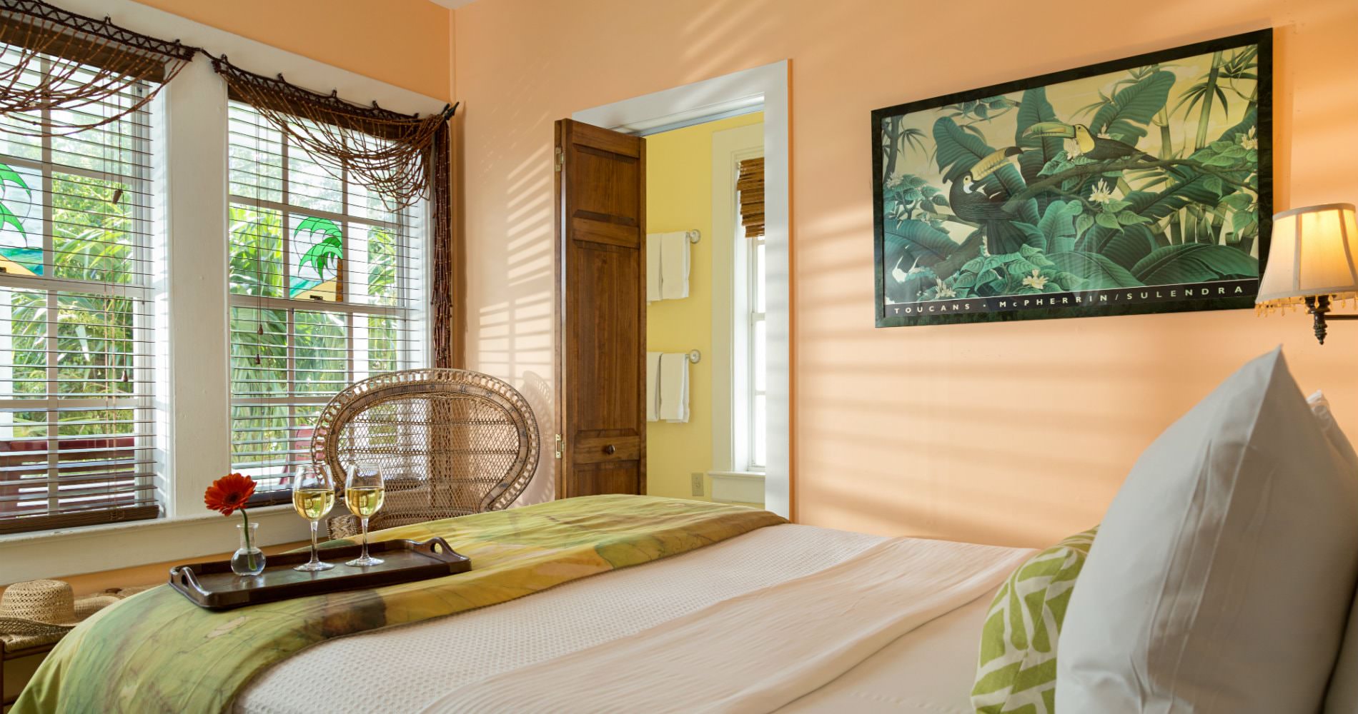 Peach room with panda painting on wall facing windows with mini blinds and connecting yellow bathroom