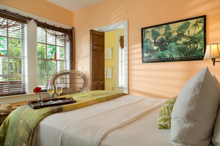 Peach room with panda painting on wall facing windows with mini blinds and connecting yellow bathroom